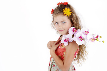 Beautiful little girl posing with orchid