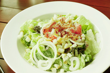 Caesar salad in white bowl.