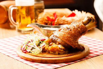 eisbein with braised cabbage, salad and beer