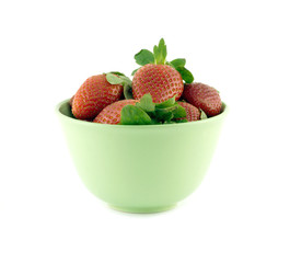 Strawberry on green bowl isolated over white closeup