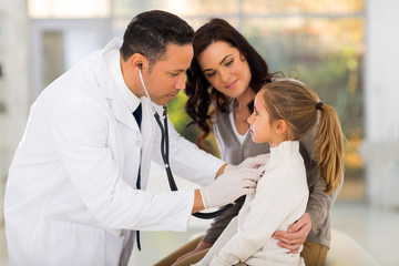 medical doctor examining a little girl