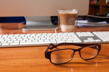 Glasses on an office desk.