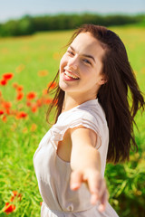 Naklejka na ściany i meble laughing young woman on poppy field