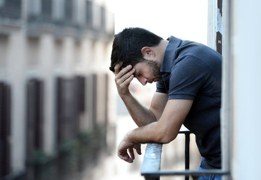 young man at balcony in depression suffering emotional