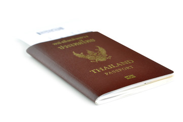 Thailand passport with air ticket in the middle