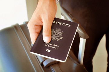 Hand holding U.S. passport - sepia retro style effect