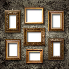 Gilded wooden frames for pictures on old stone wall