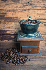 Old coffee grinder and coffee beans