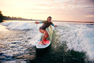 Female surfboarder - obrazy, fototapety, plakaty