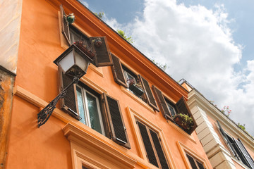 Fototapeta na wymiar Picturesque Italian house with flowers on the windows