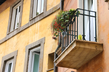 Fototapeta na wymiar Picturesque Italian house with flowers on the balconies