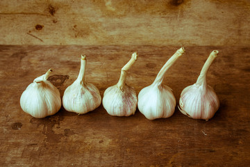 Still life with garlic on the old wooden background