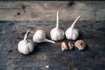 Still life with garlic on the old wooden background