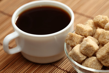 Coffee cup and brown cane sugar