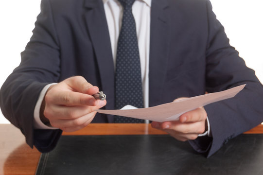 Businessman offering pen and documents for signing