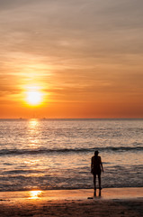 Fototapeta premium beautiful sunset beach with a young woman