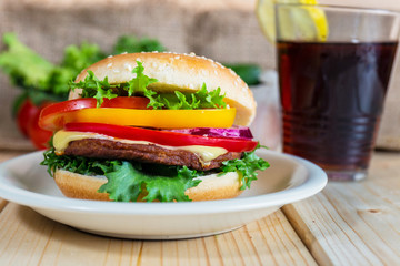 hamburger and drink with slice of lemon