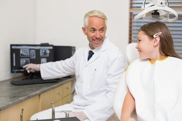 Fototapeta premium Dentist explaining xrays to little girl