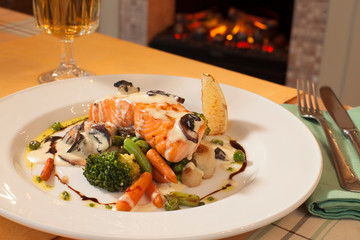 salmon grill in white sauce with vegetables, restaurant dish