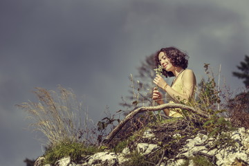 Happy woman smelling bunch of wild flowers
