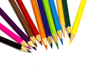 Colour pencils on white background close up