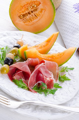 Ham with melon and olives
