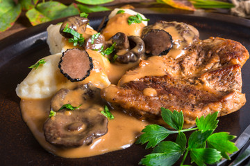 Steak with potato dumplings and forest mushroom sauce