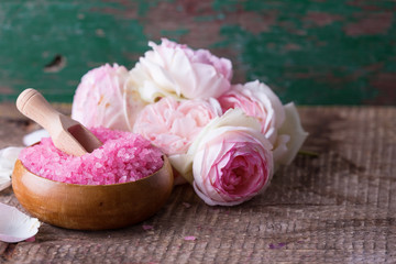 Sea salt in bowl with roses. Spa setting.