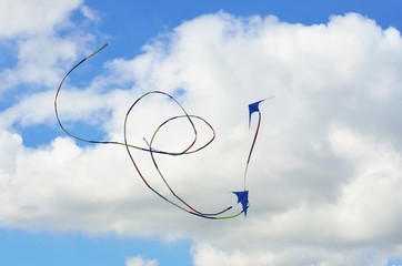 Two kites flying in formation