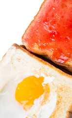 Bread toast with fried egg and strawberry jam