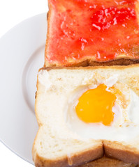 Bread toast with fried egg and strawberry jam