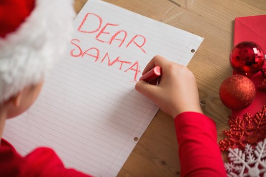 Little Girl Writing Letter To Santa At Christmas