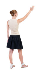 Fototapeta premium Back view of beautiful woman welcomes.