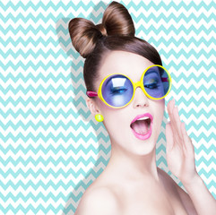 Attractive surprised young woman wearing sunglasses