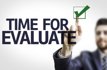Business man pointing the text: Time For Evaluate