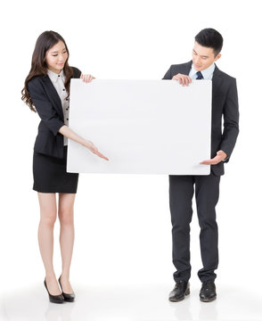 Business man and woman holding blank white board