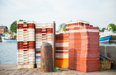 Empty container boxes arranges in piles on the pier