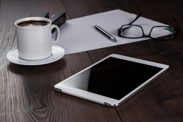 table of businessman with tablet computer and coffee