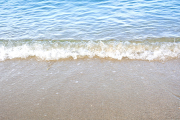 Wave of the sea on the sand beach background