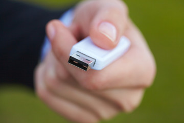 hand holding black USB data storage