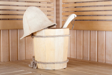 Fototapeta na wymiar Traditional wooden sauna for relaxation with bucket of water