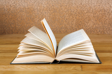 Old open book on grunge wooden table