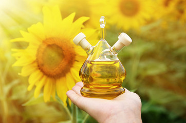 Bottle of oil against sunflowers
