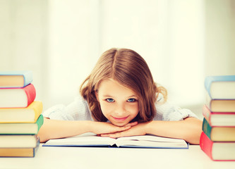 pretty girl with many books at school