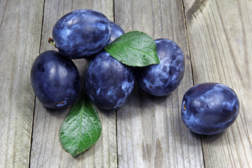 fresh plums on wooden background