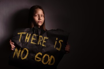 Atheist teen girl holding a banner with the inscription