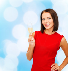 smiling woman holding glass of sparkling wine