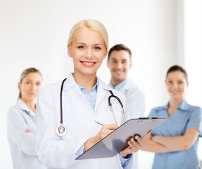 Fototapeta premium smiling female doctor with clipboard