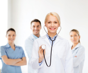 Fototapeta premium smiling female doctor with stethoscope