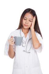 Asian young female doctor got sick with a cup of coffee